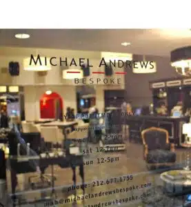 Michael Andrews Bespoke store hours and contact details on shop window
