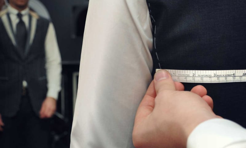 Michael Andrews Bespoke Experience - Tailor measuring client
