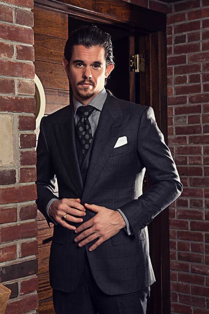 Cory in custom black suit with peak lapels