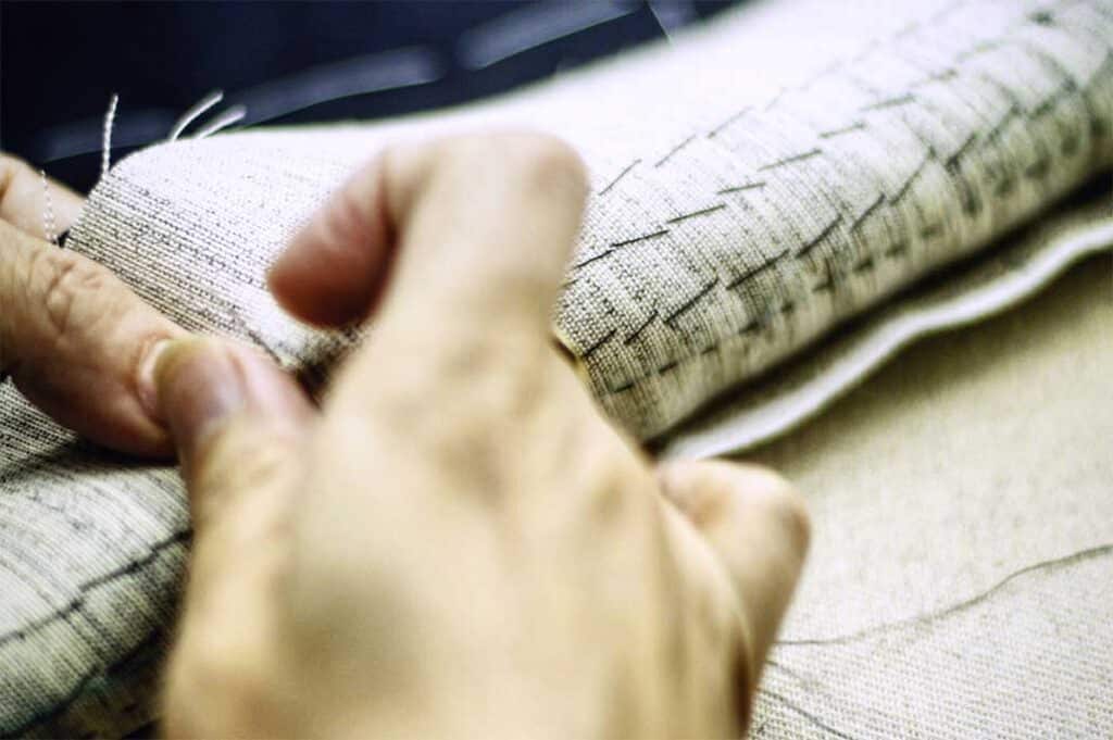 Michael Andrews Tailoring Process - Tailor's hand carefully stitching