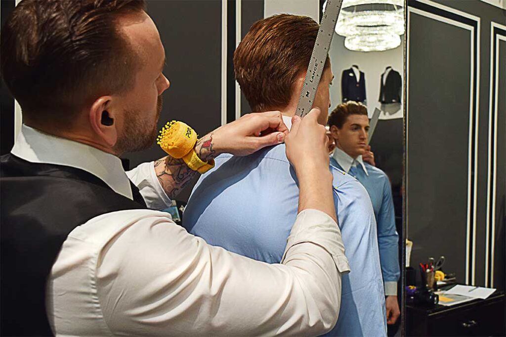 Michael Andrews Process - Tailor measuring client's shoulder width