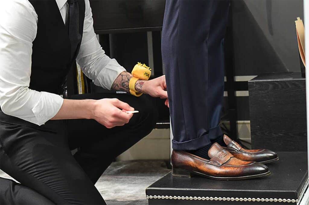 Michael Andrews Process, Tailor measuring trouser hem in fitting session