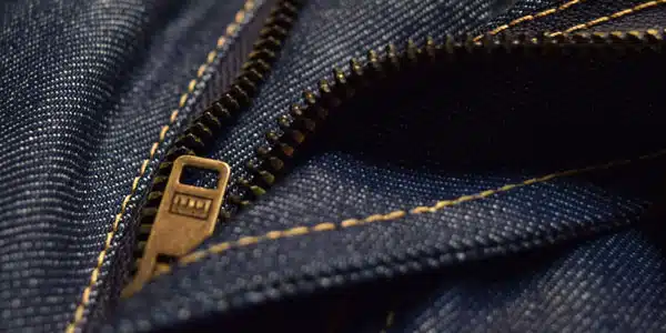 Detailed view of custom denim jeans zipper