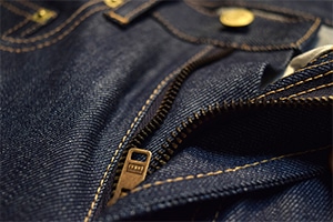 Detailed view of denim jeans zipper