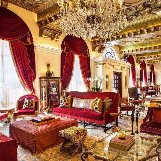 Opulent lounge in Washington, D.C. with red velvet decor and chandeliers