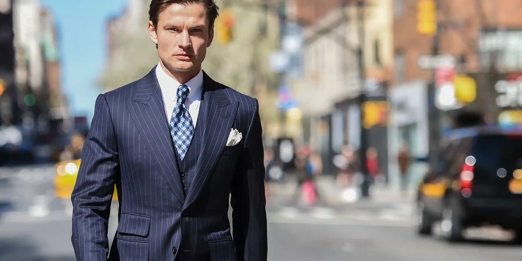 George in custom pinstripe suit, menswear banner