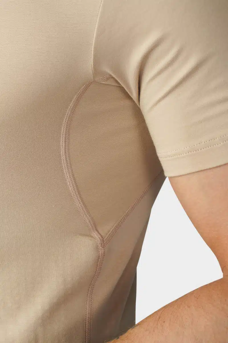 Close-up of the sleeve seam of a beige undershirt