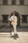 Brian wearing a cream linen suit with a white shirt and beige tie, styled with sunglasses and loafers