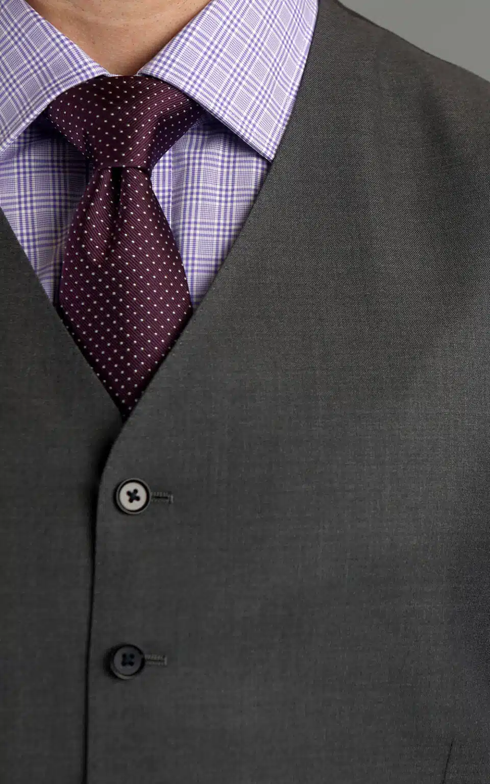 Grey sharkskin suit vest paired with a lilac shirt and textured burgundy tie