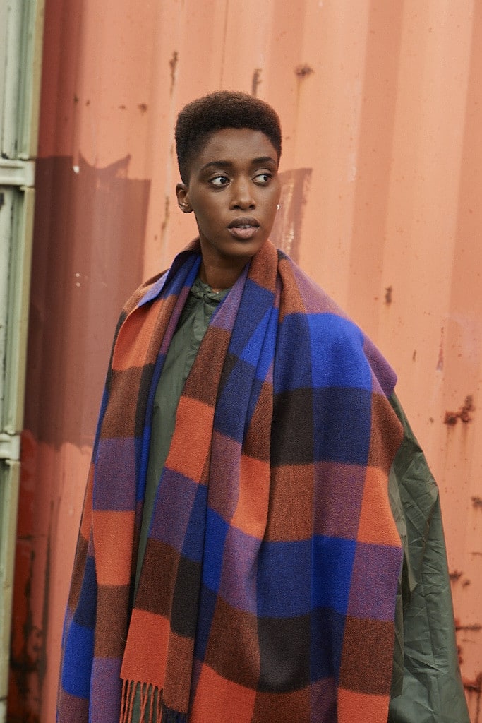 (product) Cobalt Block Check Cashmere Stole, styled against a warm-toned backdrop