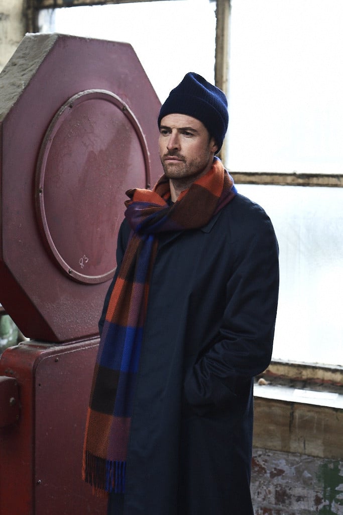 (product) Cobalt Block Check Cashmere Stole, modeled with a navy jacket and beanie