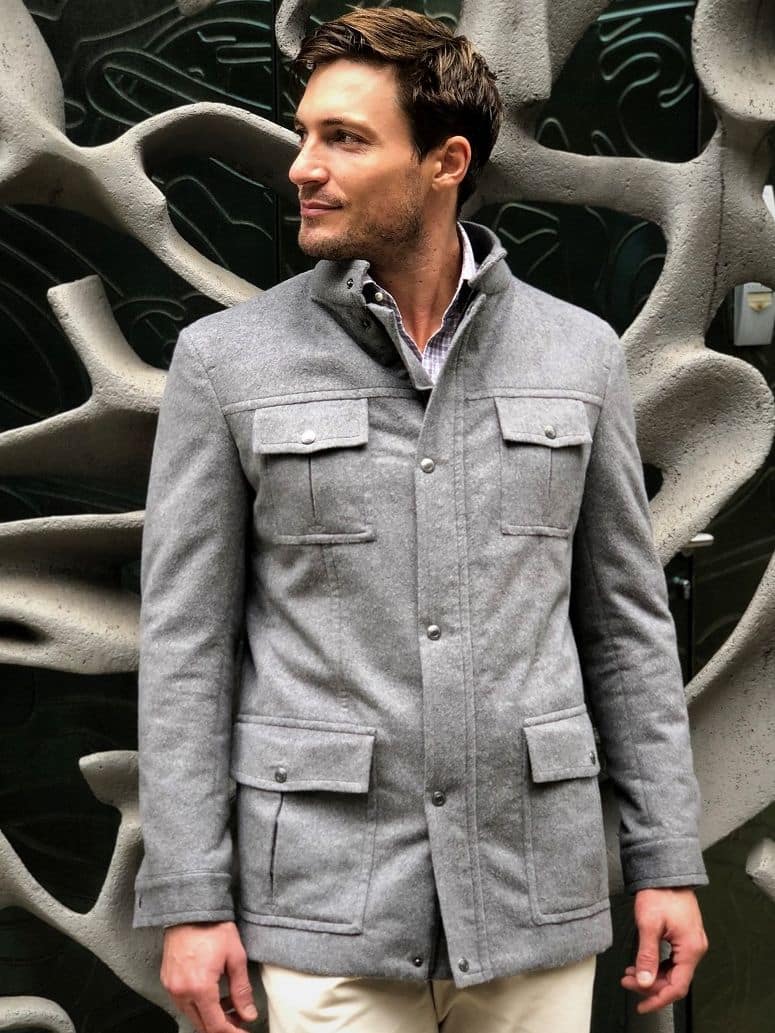 Close-up of a light grey field jacket with buttoned front details