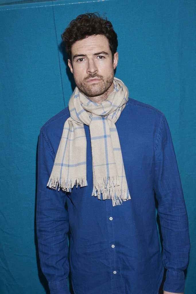 (product) Camel Lightweight Merino Semi-Plain Scarf worn by a model