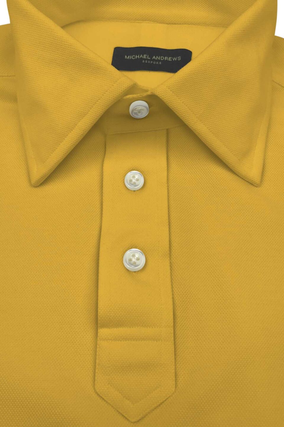 (product) Yellow Pique Polo Shirt, close-up of collar and buttons