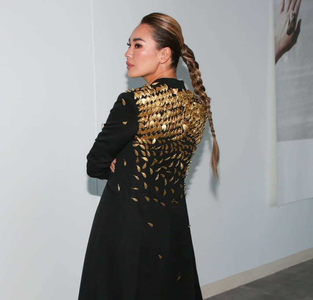 Rachel Bu, Founder of Authorne wearing a black coat adorned with gold embellishments on the back