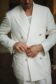Close-up view of Cory in an off white linen suit