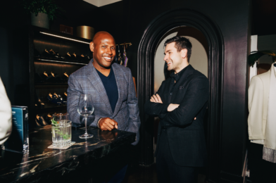 Two men dressed in tailored eveningwear—one in a navy check sport coat, the other in an all-black suit—enjoying drinks at Michael Andrews Bespoke during “A Night in Portofino” event