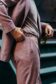 Close-up of a dusty rose blend suit with side adjuster detail, paired with a casual tee