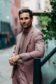 Shane in a dusty rose blend suit and taupe crewneck tee, styled with a pocket square and watch