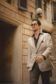 Cory walking in a tan linen sport coat over a brown shirt and trousers - custom suits nyc bespoke tailor midtown, noho