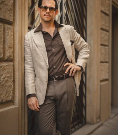 Cory wearing a tan linen sport coat with a brown shirt and trousers
