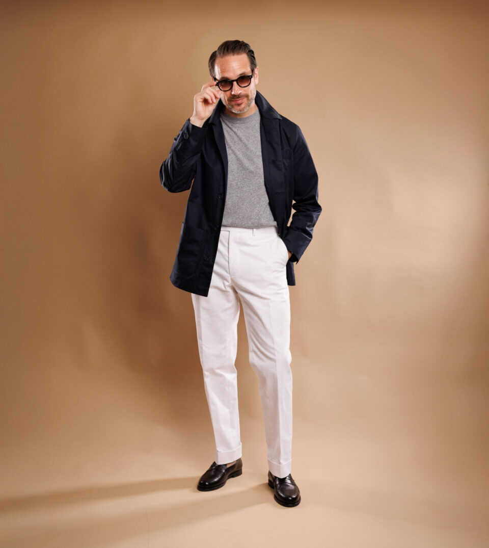 Full-body look with navy twill chore coat, casual gray top, and tailored white trousers