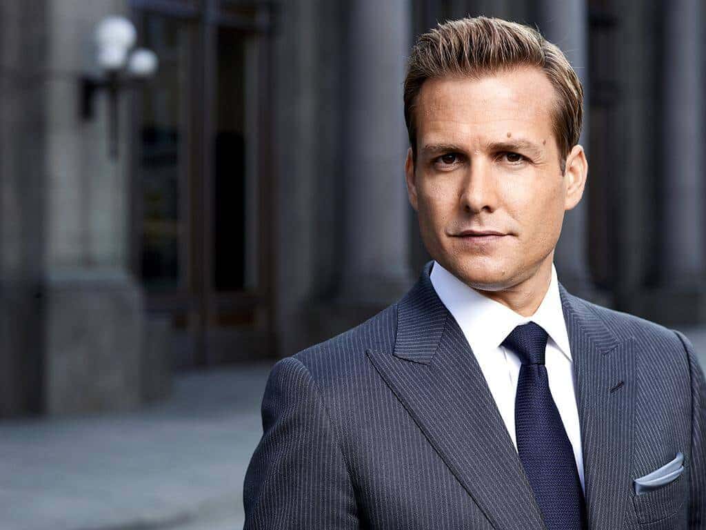 harvey-specter-fine-pinstripe-suit-with-navy-grenadine-tie Charcoal pinstripe peak lapel suit with white shirt, navy grenadine tie and pocket square, worn by a model