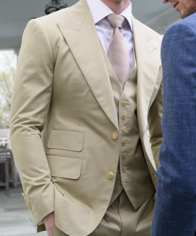 Tan three-piece custom suit with notch lapel, matching waistcoat and tie, styled with a light dress shirt in an outdoor setting, paired with a blue suit, Kentucky Derby style guide. - custom suits nyc bespoke tailor midtown, noho