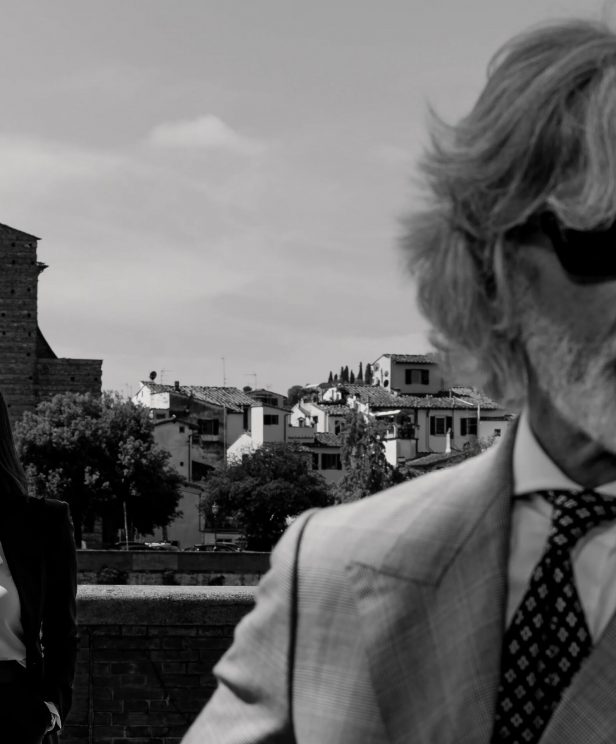 Black-and-white Florence portrait of two tailored figures overlooking the city, capturing the Michael Andrews Bespoke x Dormeuil lookbook’s blend of modern elegance and timeless cloth.