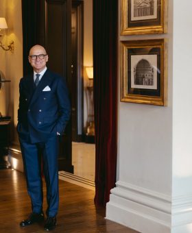 Domenico Colella, General Manager of The St. Regis Florence, standing inside the hotel in a navy double-breasted suit for MAB’s 20 for 20 lookbook.