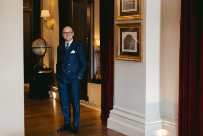 Domenico Colella, General Manager of The St. Regis Florence, standing inside the hotel in a navy double-breasted suit for MAB’s 20 for 20 lookbook.