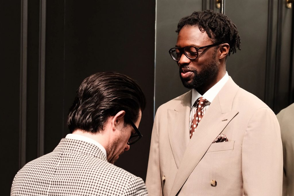 Oneil Gardner during a final fitting wearing a beige double-breasted suit in Dormeuil Tonik Wool for MAB’s 20 for 20 lookbook.