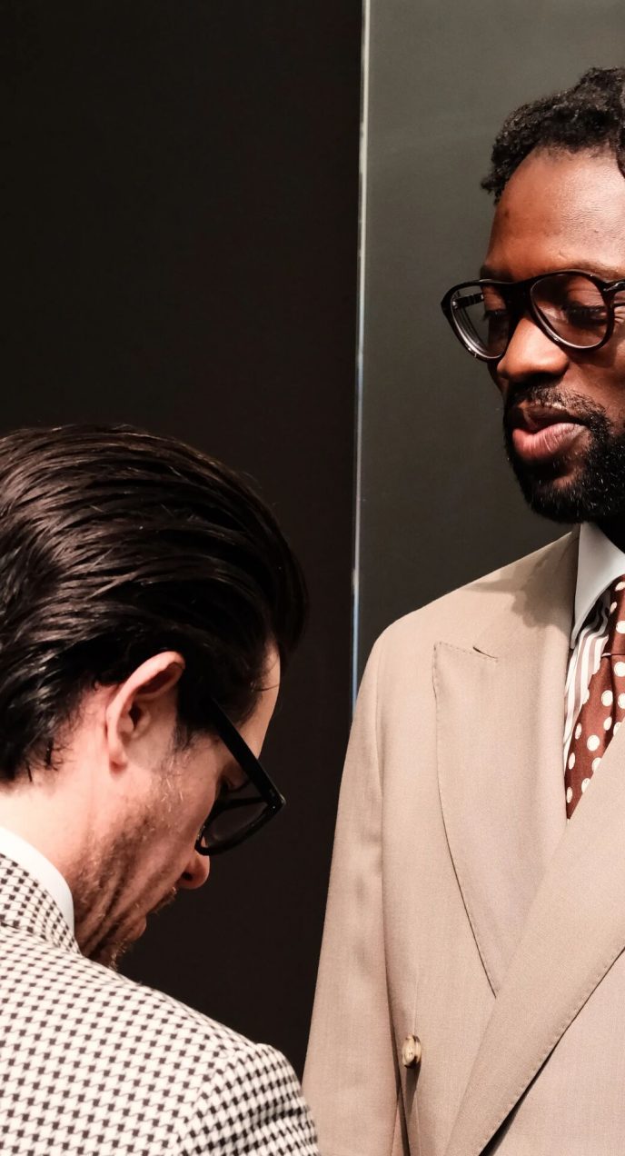 Oneil Gardner during a final fitting wearing a beige double-breasted suit in Dormeuil Tonik Wool for MAB’s 20 for 20 lookbook.