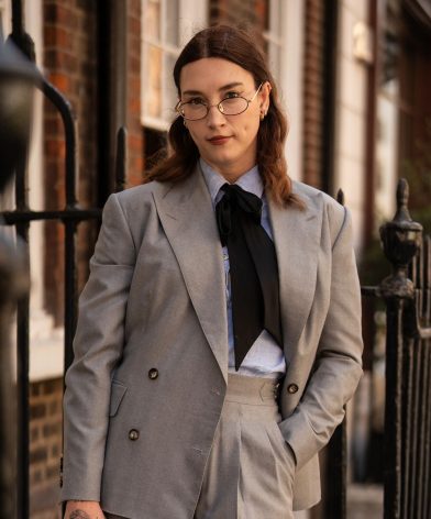 Brit Bones wearing a grey herringbone suit in Dormeuil Pashmina for Look No. 12 of Michael Andrews Bespoke’s 20 for 20 lookbook.