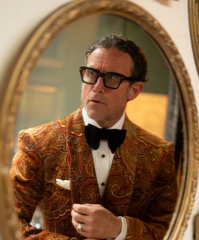 Peter Zottolo reflected in a mirror wearing a bold paisley velvet dinner jacket from Dormeuil’s Celebration collection for MAB’s 20 for 20 lookbook.